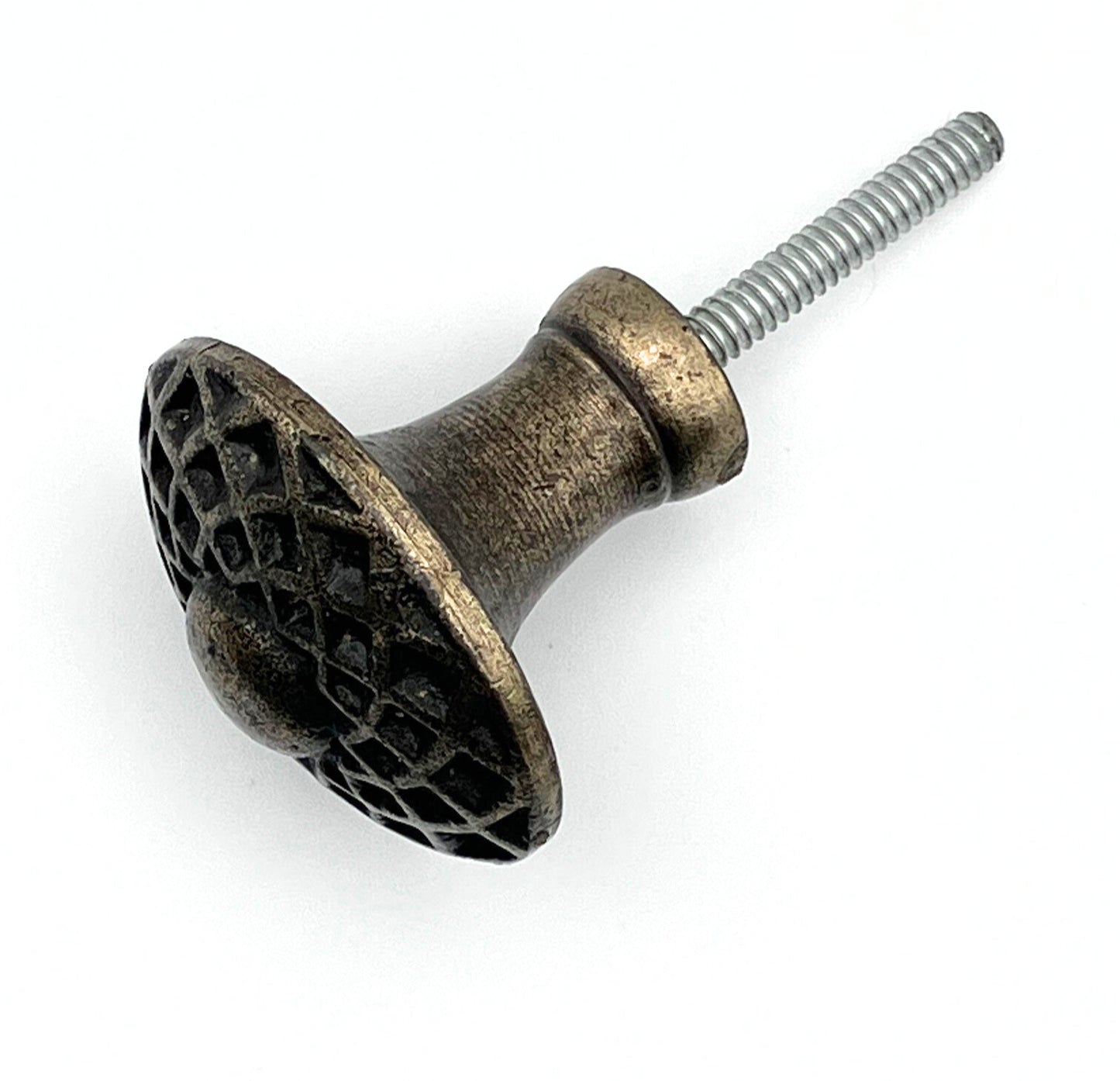 Decorative metal knob with textured surface and screw on a white background