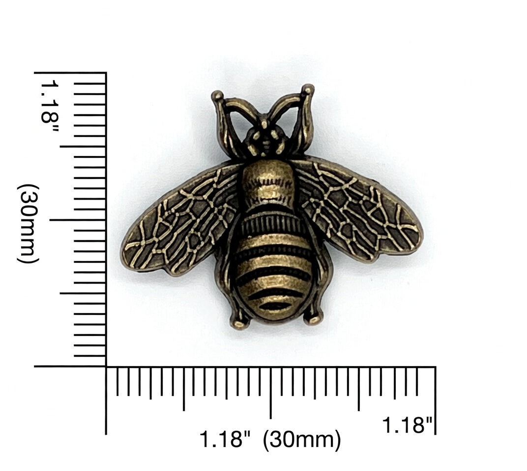 Bronze bee knob with measurement scale on a white background