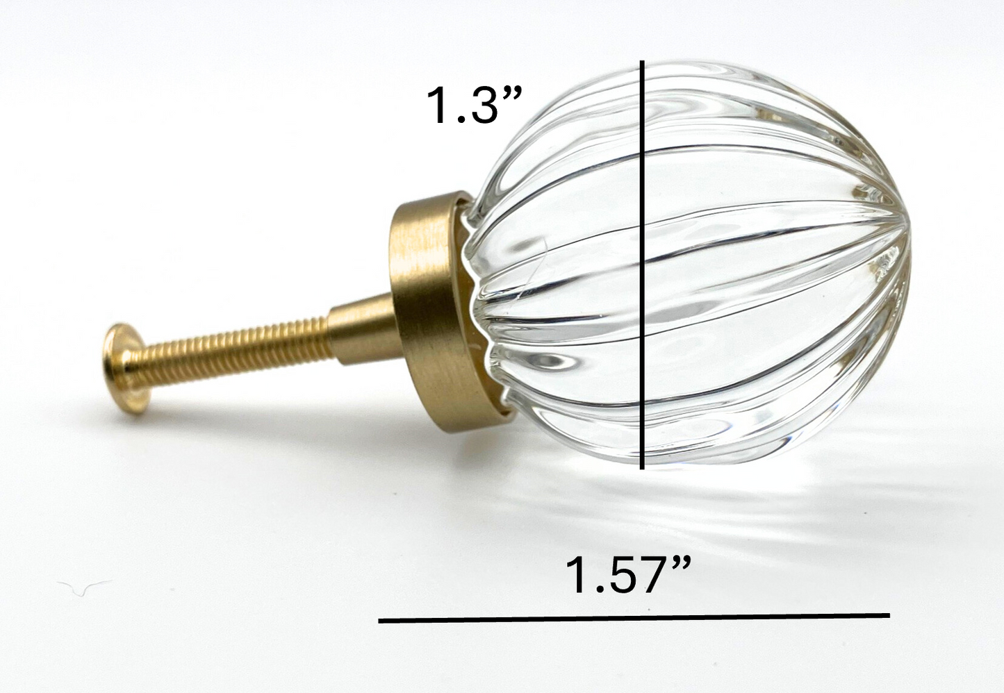 Clear glass knob with gold base and measurements on a white background
