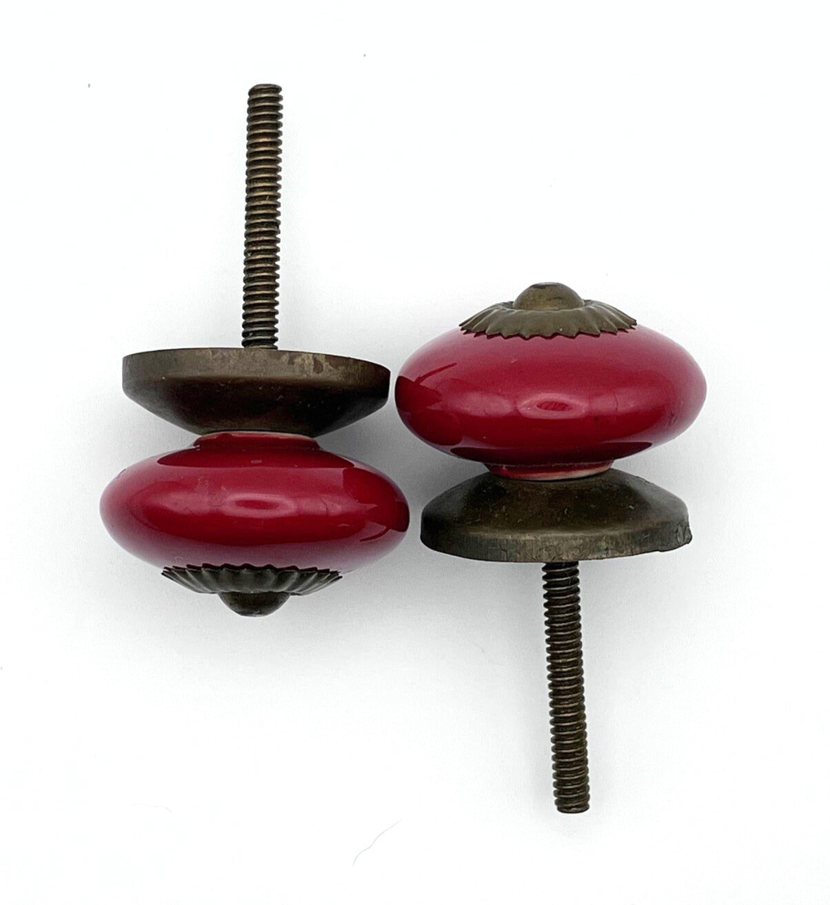 Two red ceramic cabinet knobs on a white background