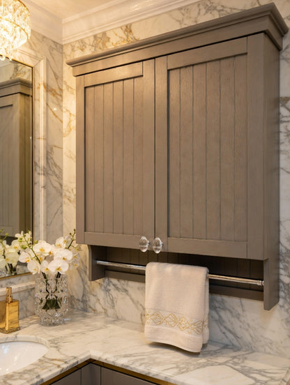 Bathroom cabinet with marble countertop and decorative towel