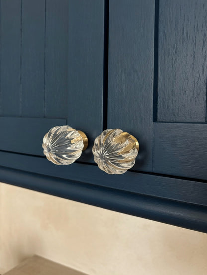 Close-up of navy blue cabinet with crystal glass knobs