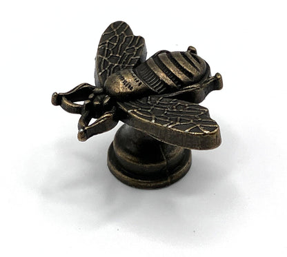 Bronze bee-shaped knob on a white background