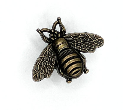Bronze bee-shaped knob on a white background