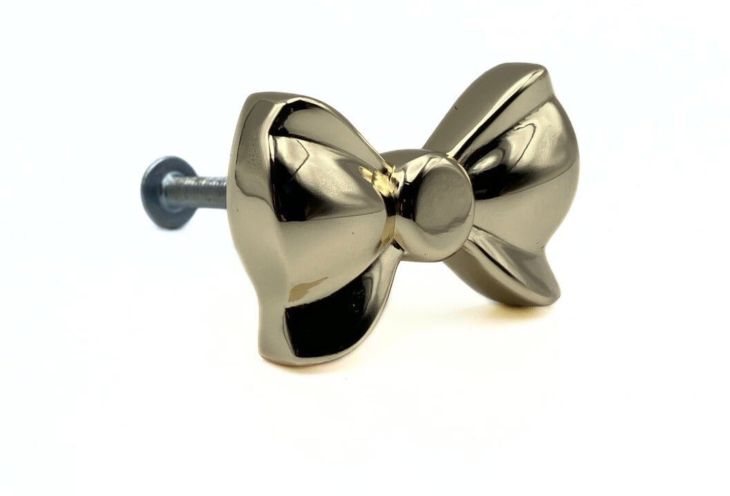 Brass gold button bow knob on a white background