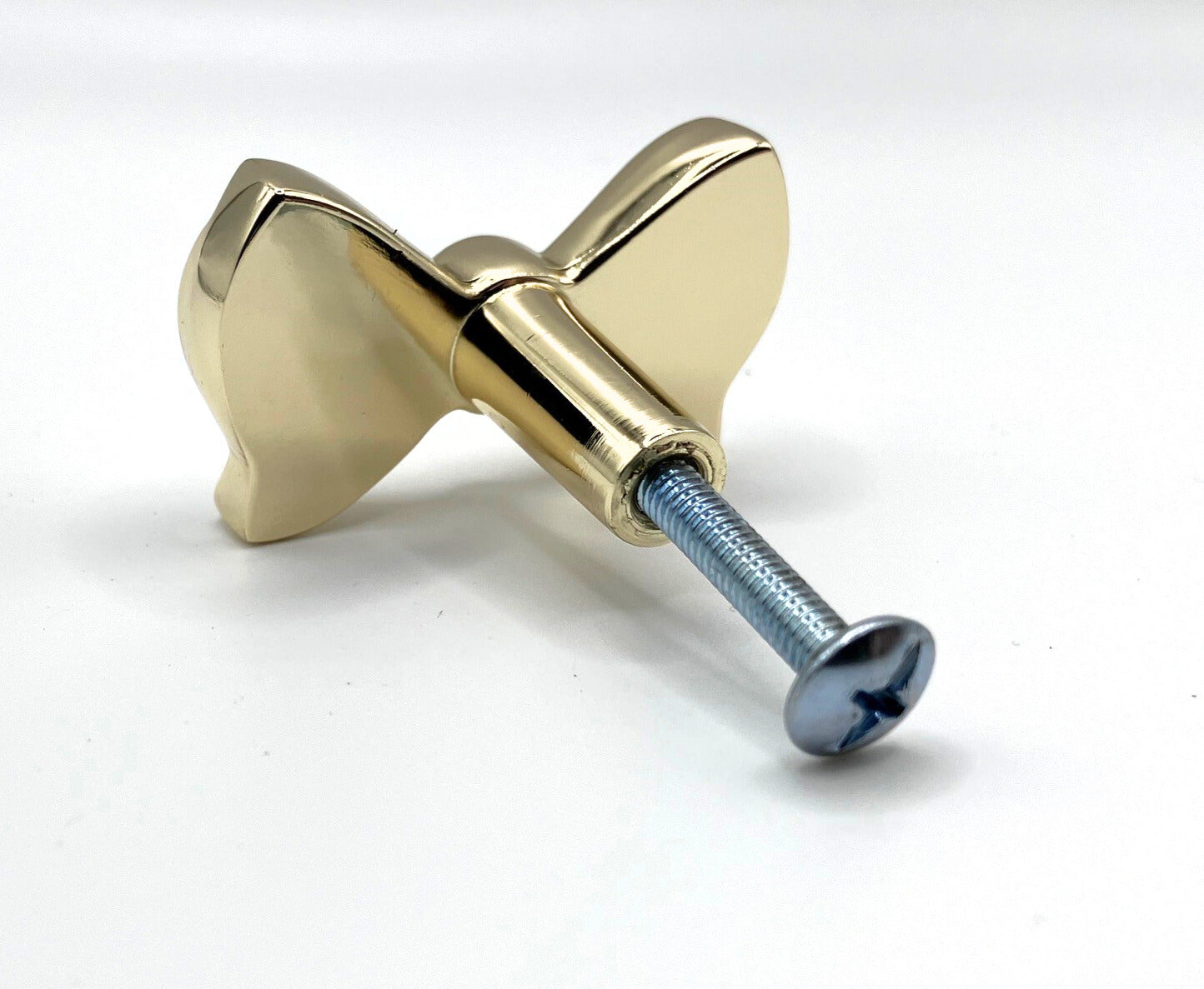 Brass gold button bow knob on a white background
