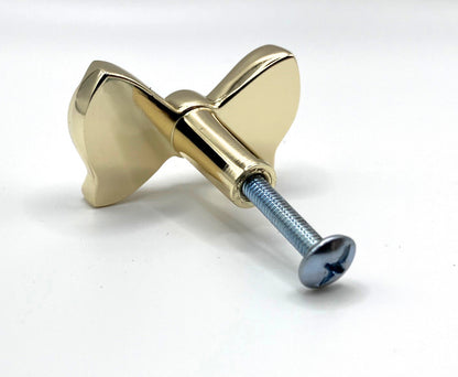 Brass gold button bow knob on a white background