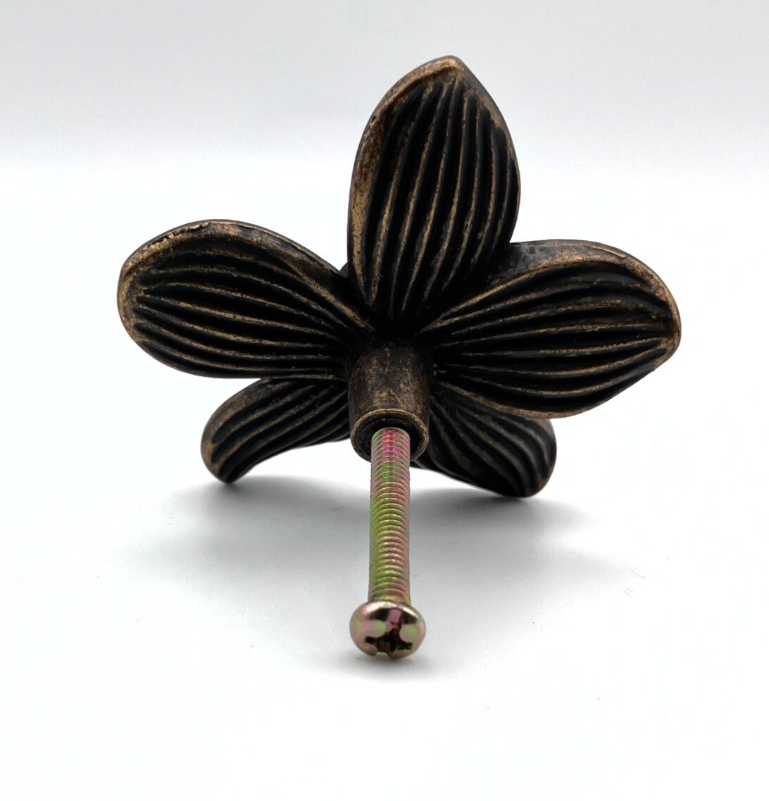 Decorative metal knob with a floral design on a white background