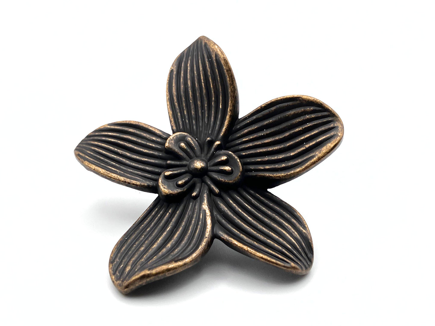 Bronze flower-shaped decorative knob on a white background