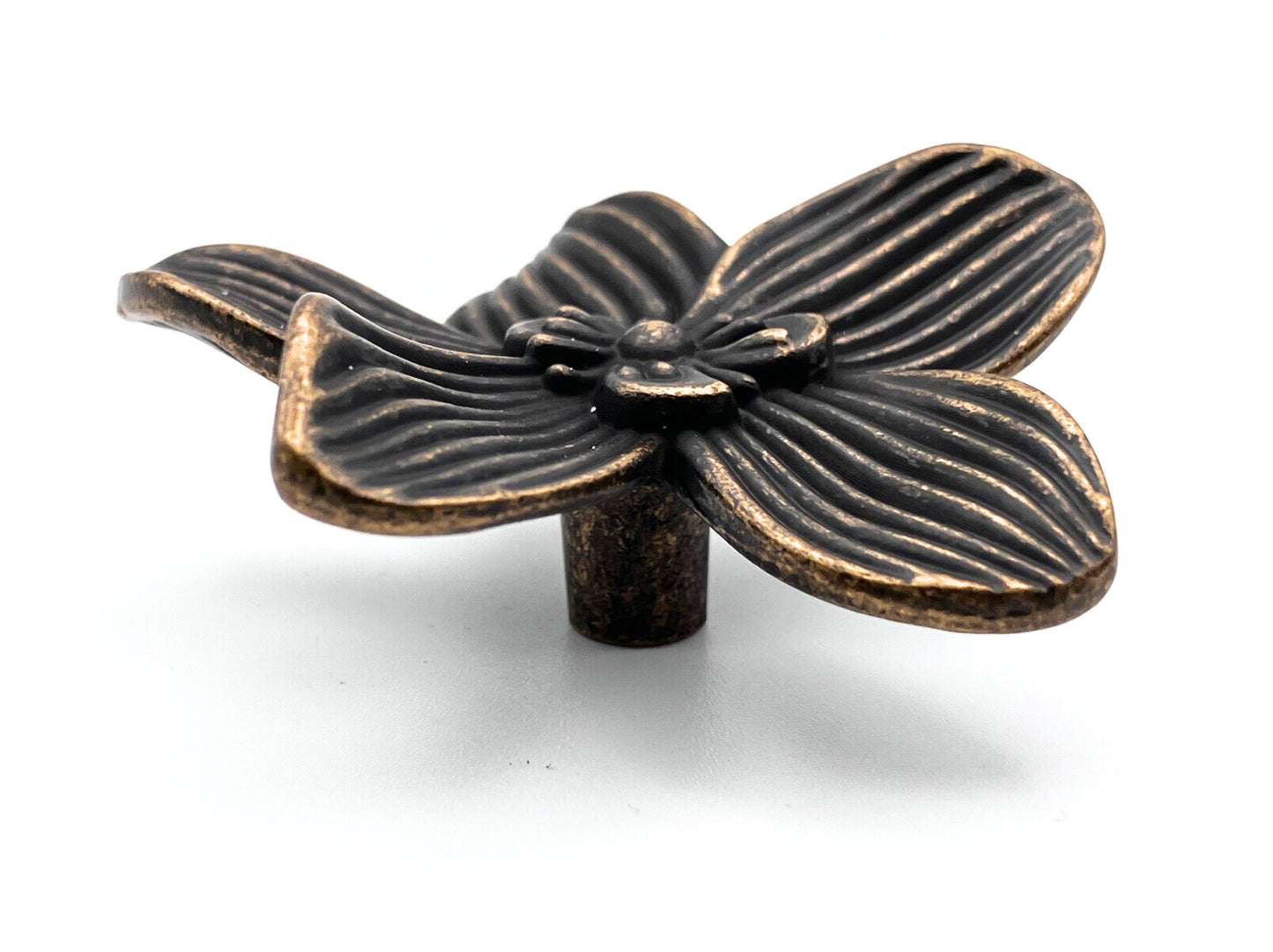 Bronze flower-shaped knob on a white background