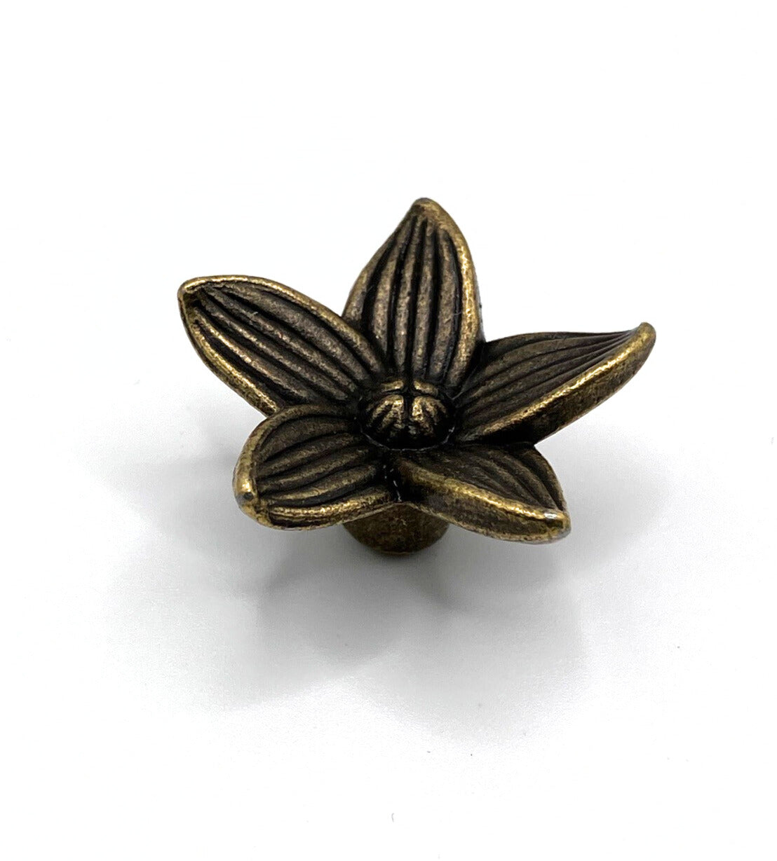 Bronze flower-shaped knob on a white background