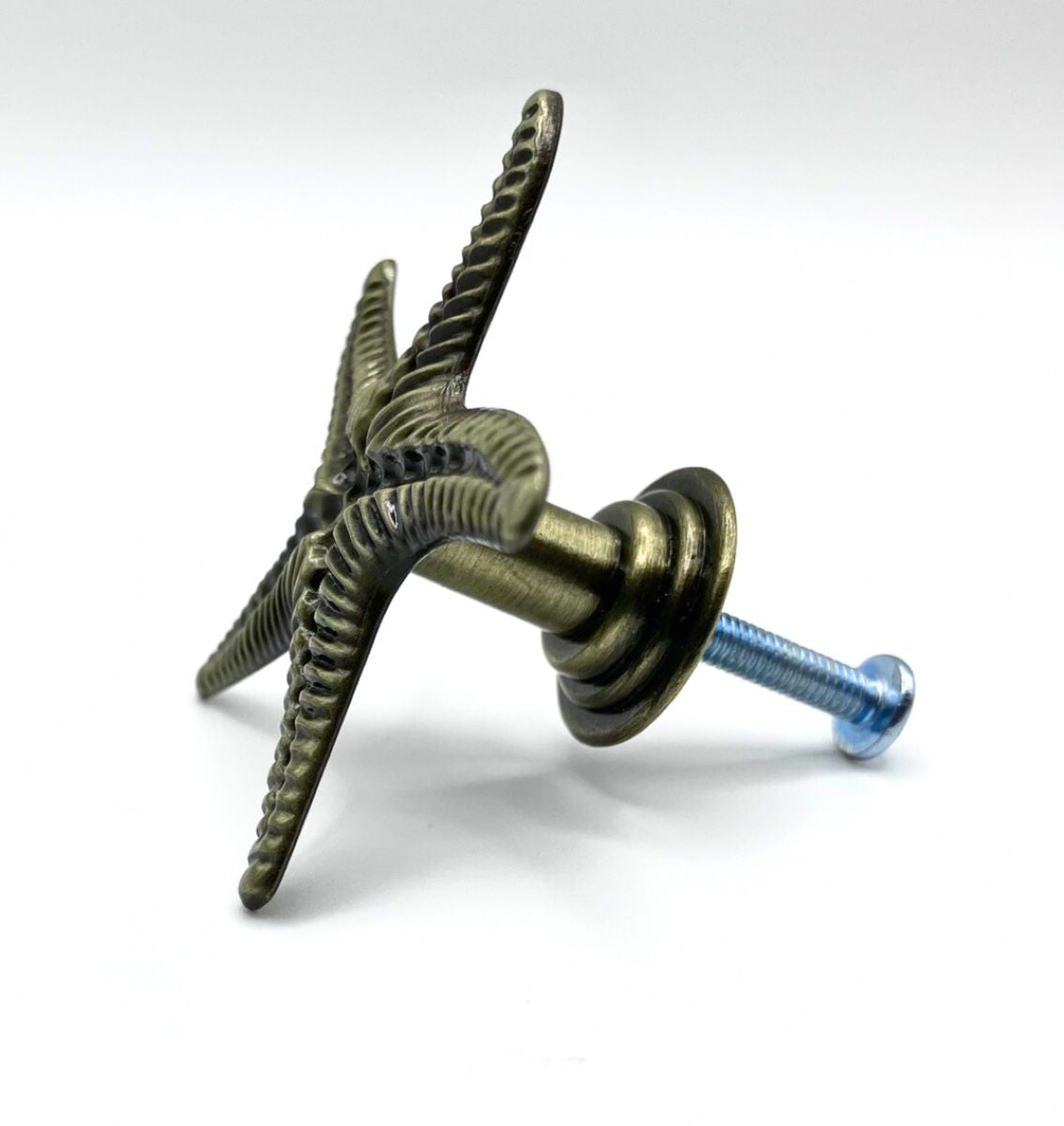 Decorative metal knob with starfish design on a white background