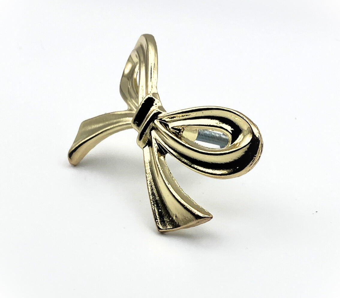 Brass gold bow knob on a white background