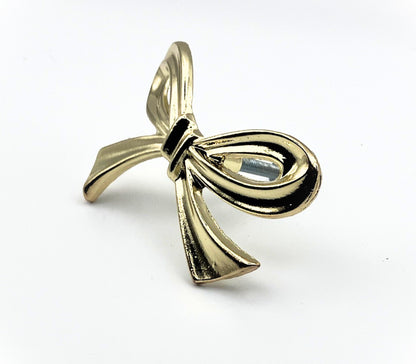 Brass gold bow knob on a white background