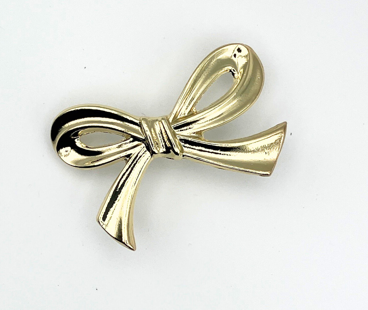 Brass gold bow knob on a white background