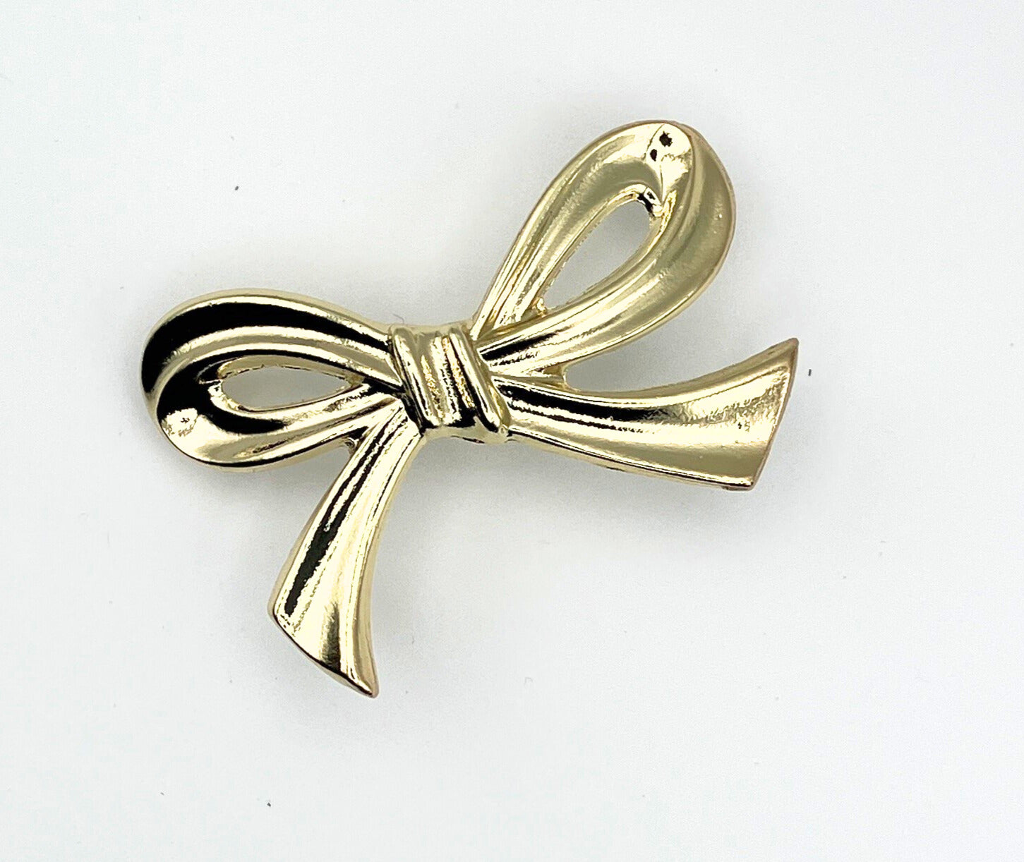 Brass gold bow knob on a white background