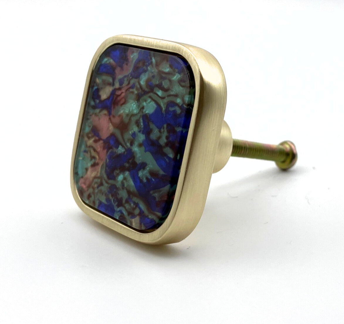 Decorative knob with multicolored stone and gold finish on a white background