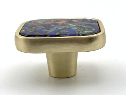 Brass cabinet knob with a colorful stone inlay on a white background