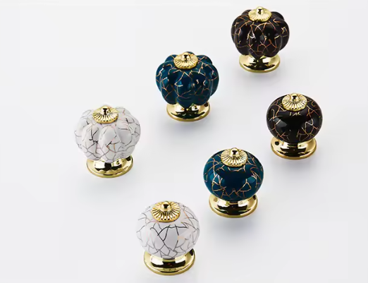 Set of decorative cabinet knobs with marble and crackle glaze finishes on a white background