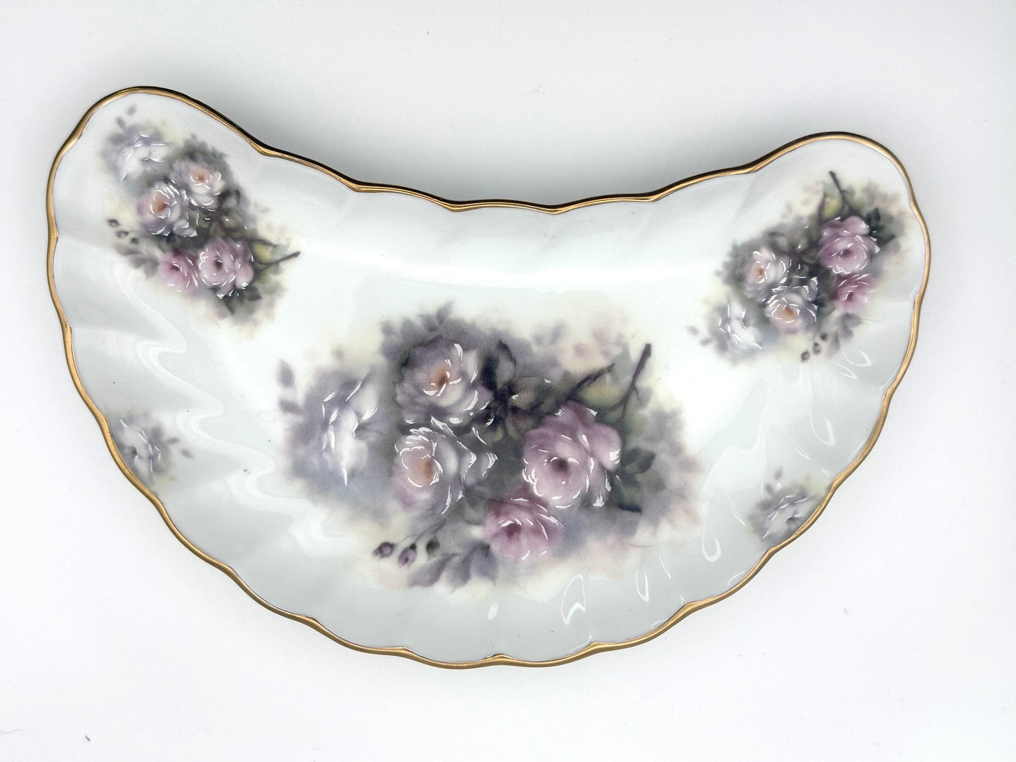 Vintage porcelain bone dish with curved crescent silhouette and floral pattern