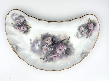 Vintage porcelain bone dish with curved crescent silhouette and floral pattern