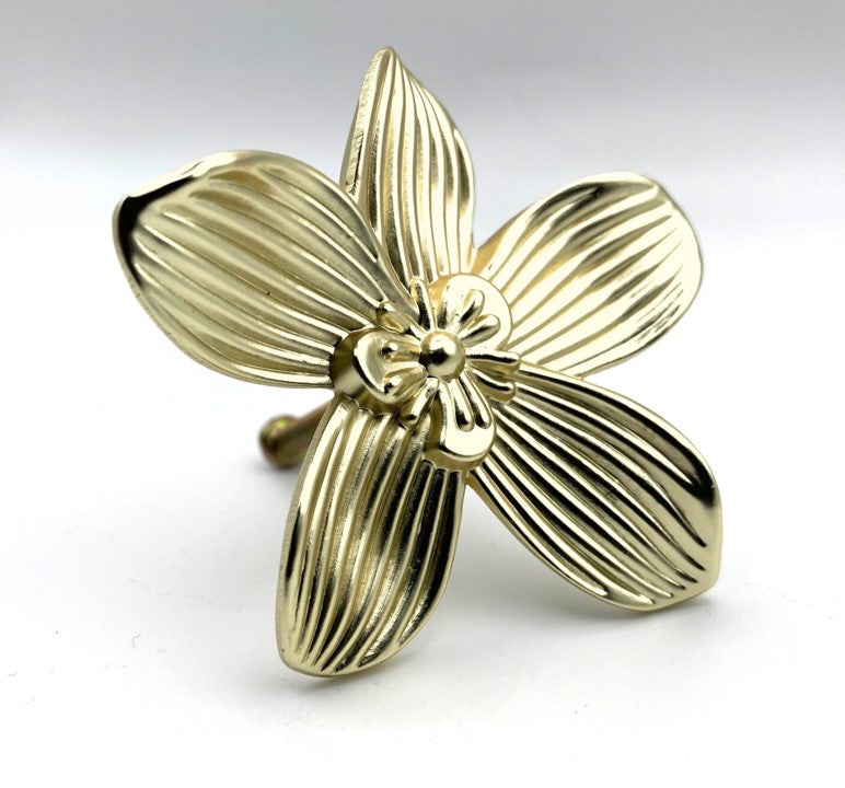 Gold brass flower-shaped knob on a white background