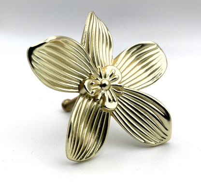 Gold brass flower-shaped knob on a white background