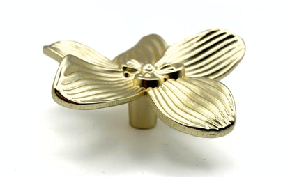 gold flower-shaped decorative knob on a white background