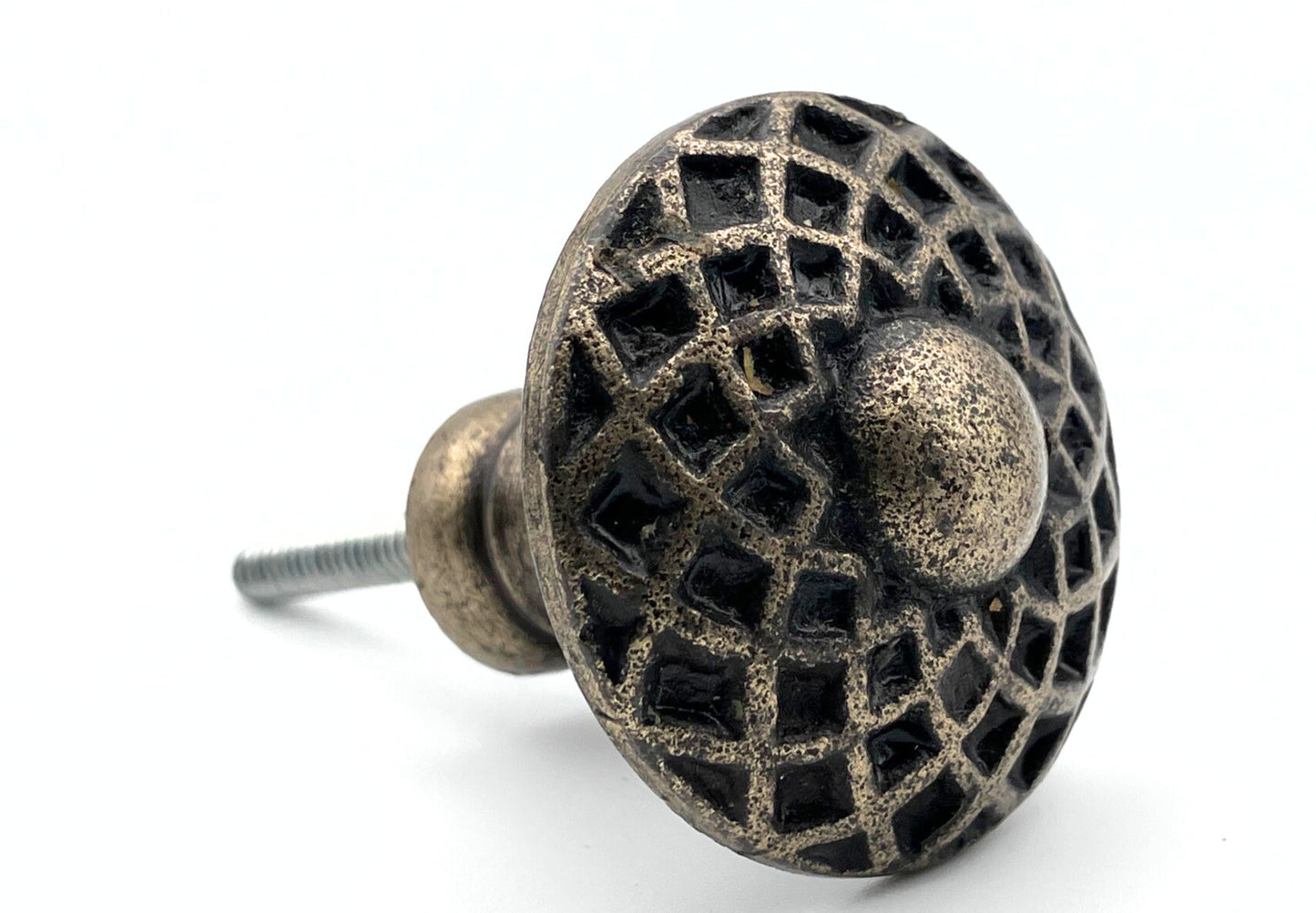 Decorative metal knob with intricate design on a white background