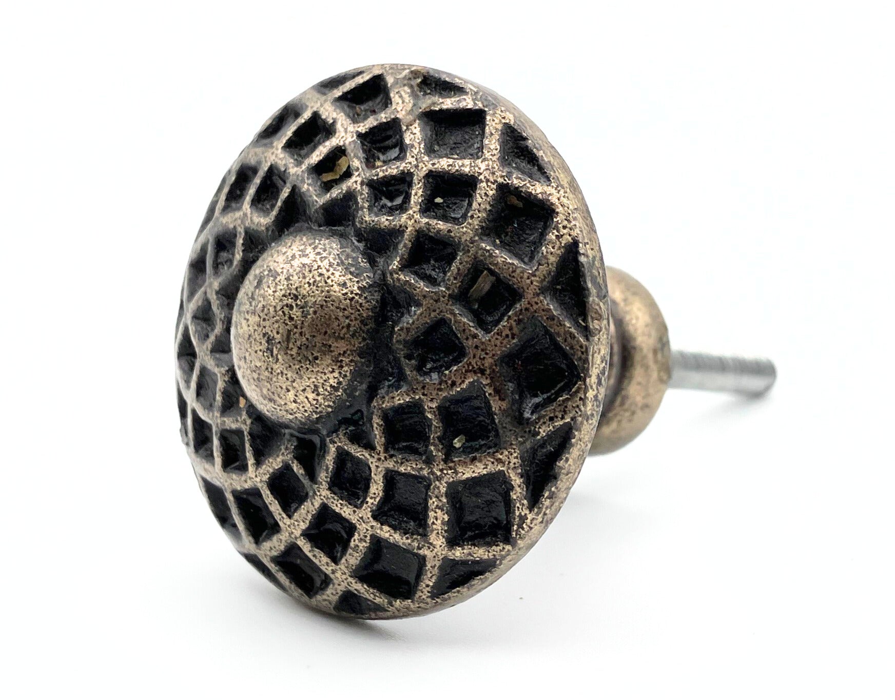 Decorative metal knob with intricate design on a white background