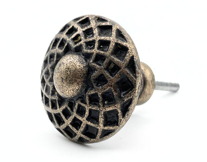 Decorative metal knob with intricate design on a white background
