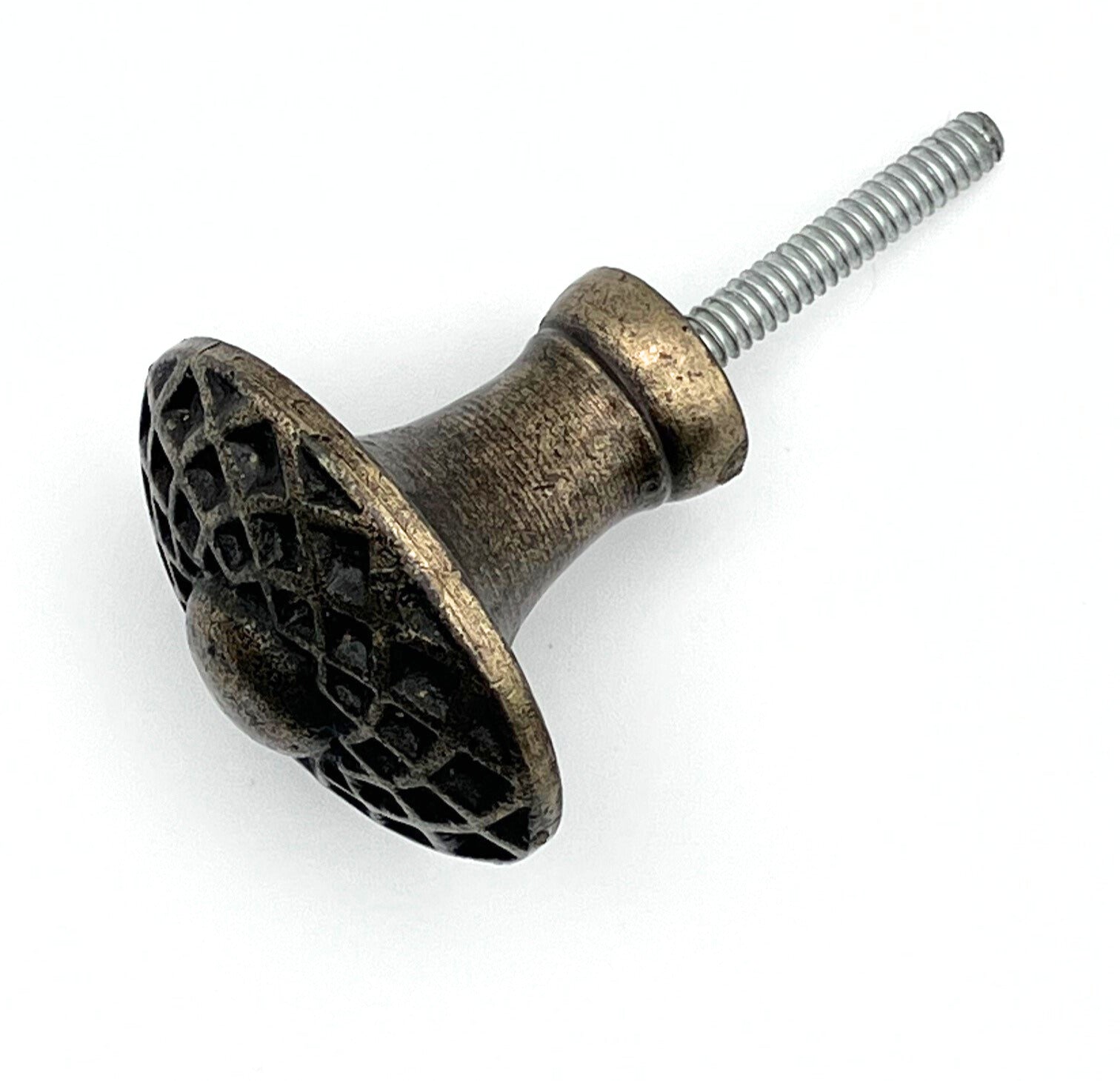 Decorative metal knob with textured surface and screw on a white background