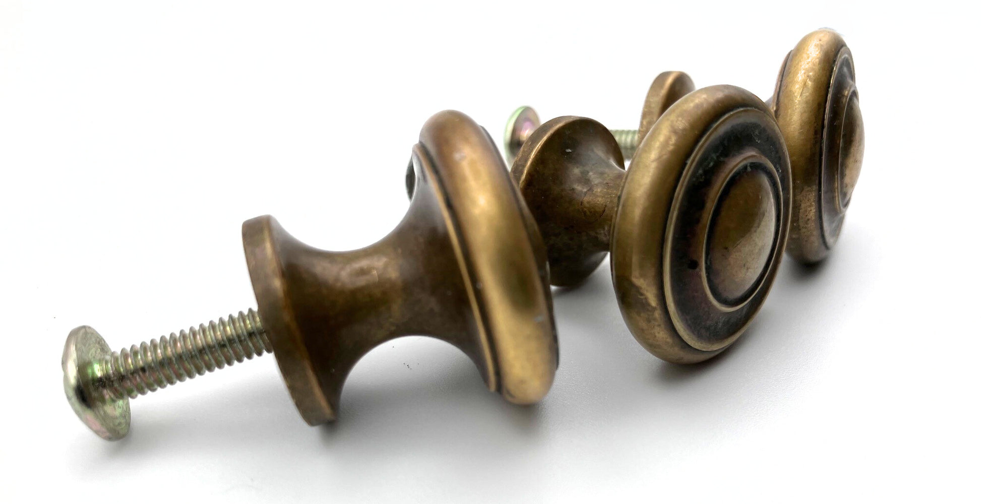 Set of brass cabinet knobs on a white background
