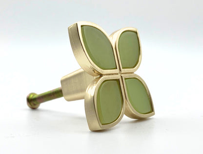 Decorative knob with gold and green design on a white background