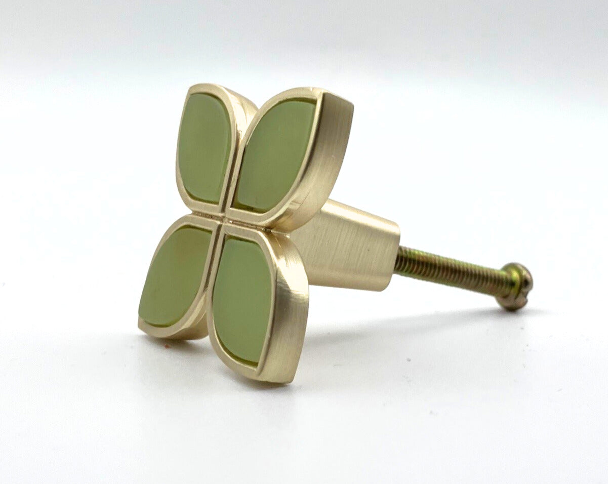 Decorative knob with gold and green design on a white background