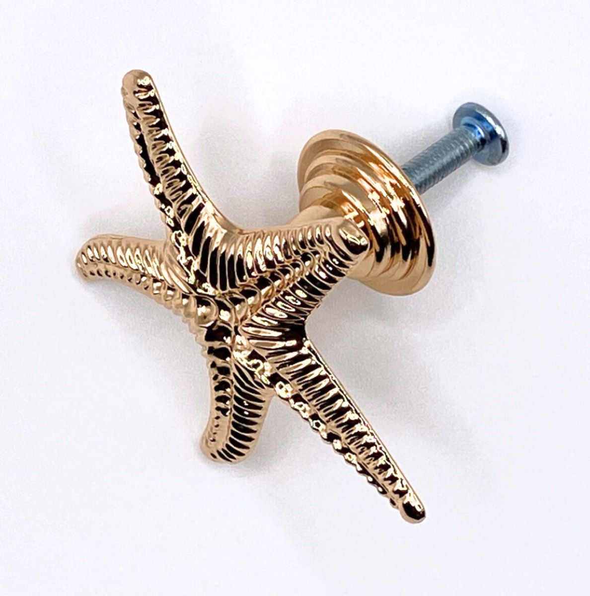 Gold starfish-shaped cabinet knob on a white background