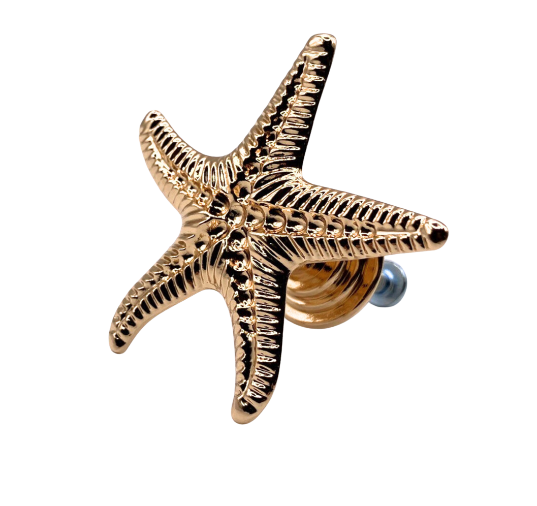 Gold starfish-shaped knob on a white background