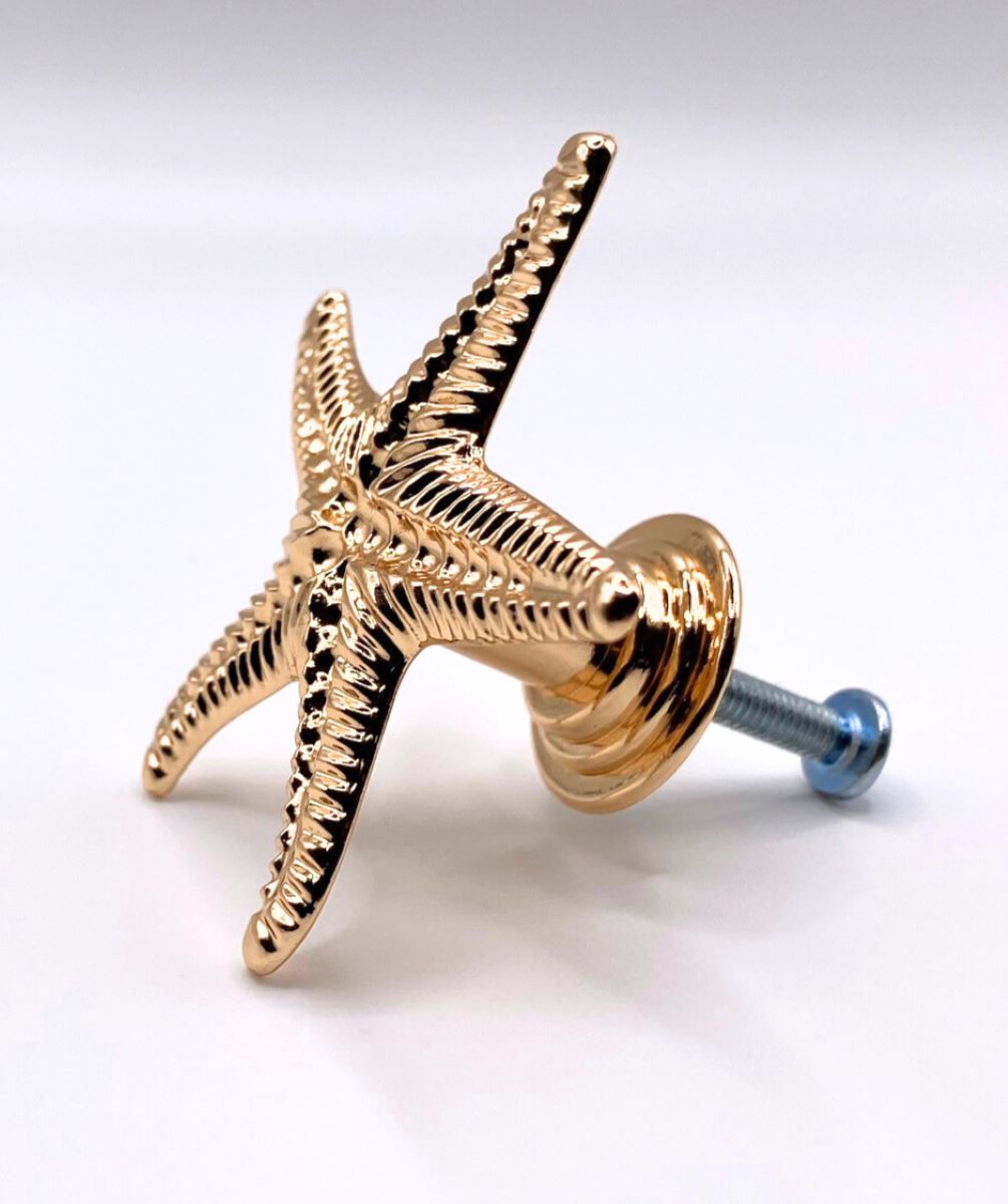 Gold starfish-shaped knob on a white background