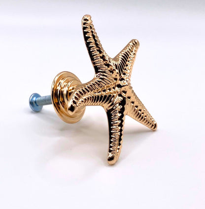 Gold starfish-shaped knob on a white background