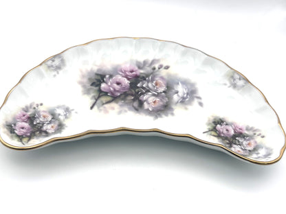 Decorative vintage crescent dish adorned with colorful floral motifs and classic styling