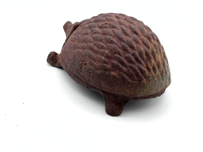 Rust-colored hedgehog figurine on a white background