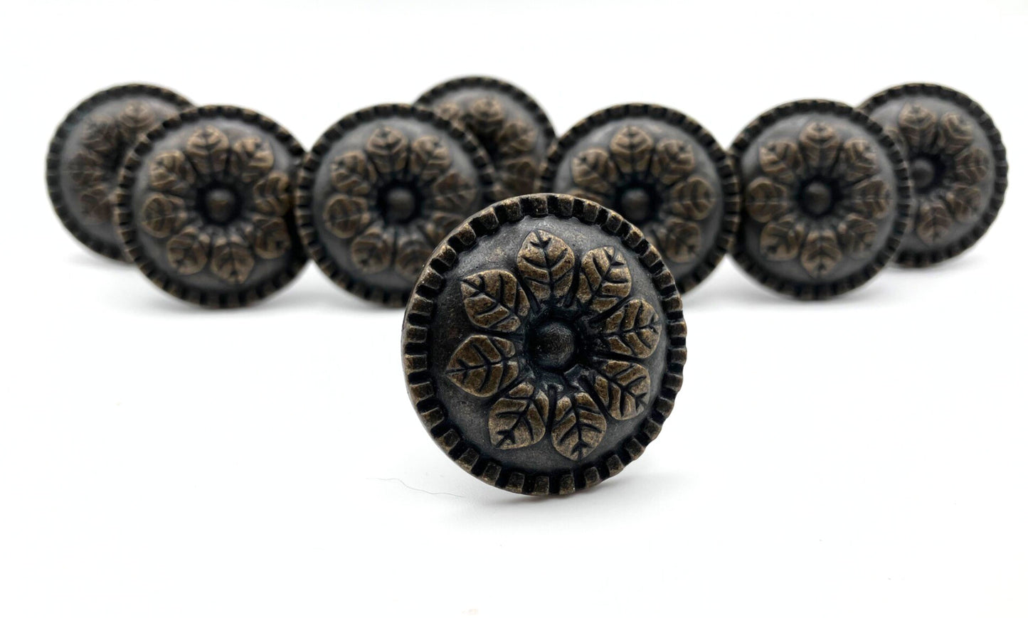 Decorative knobs with intricate designs on a white background