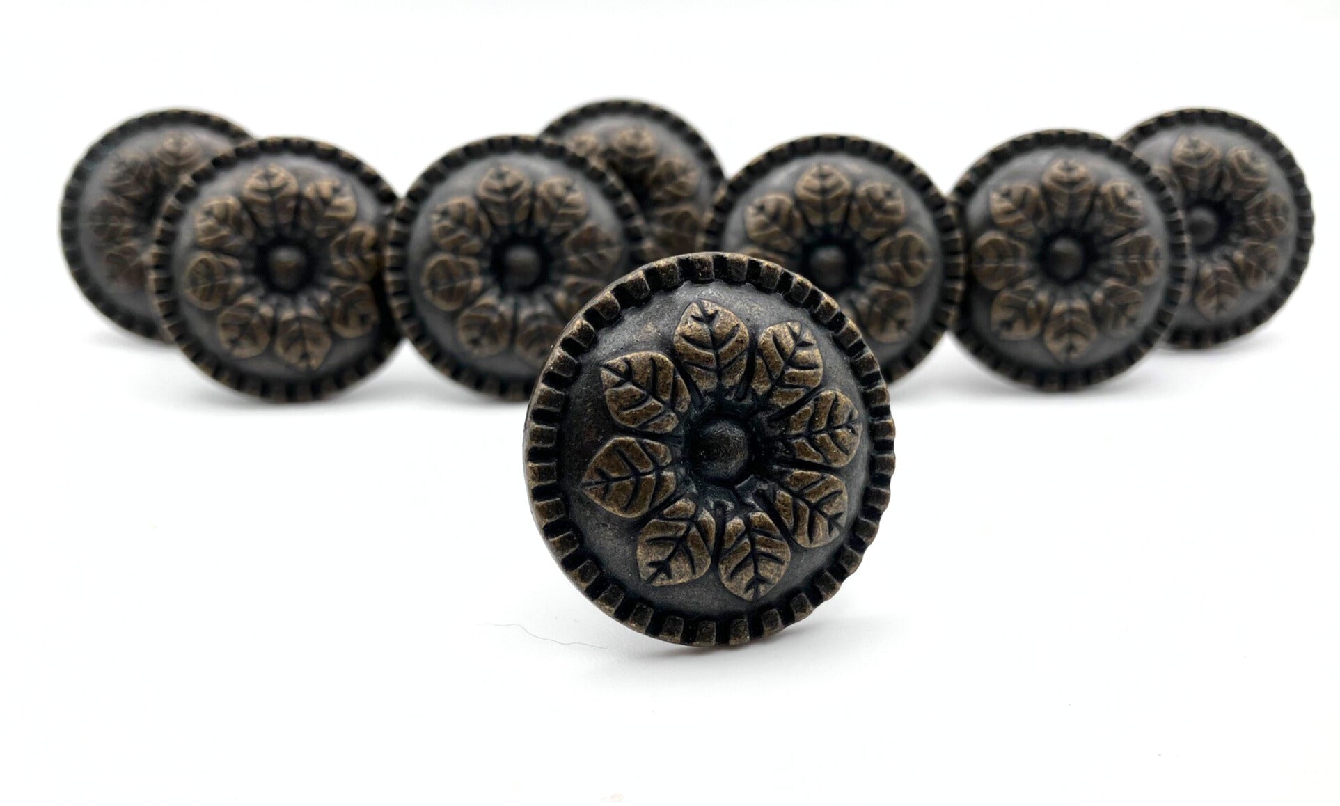 Decorative knobs with intricate designs on a white background