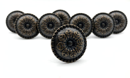 Decorative knobs with intricate designs on a white background