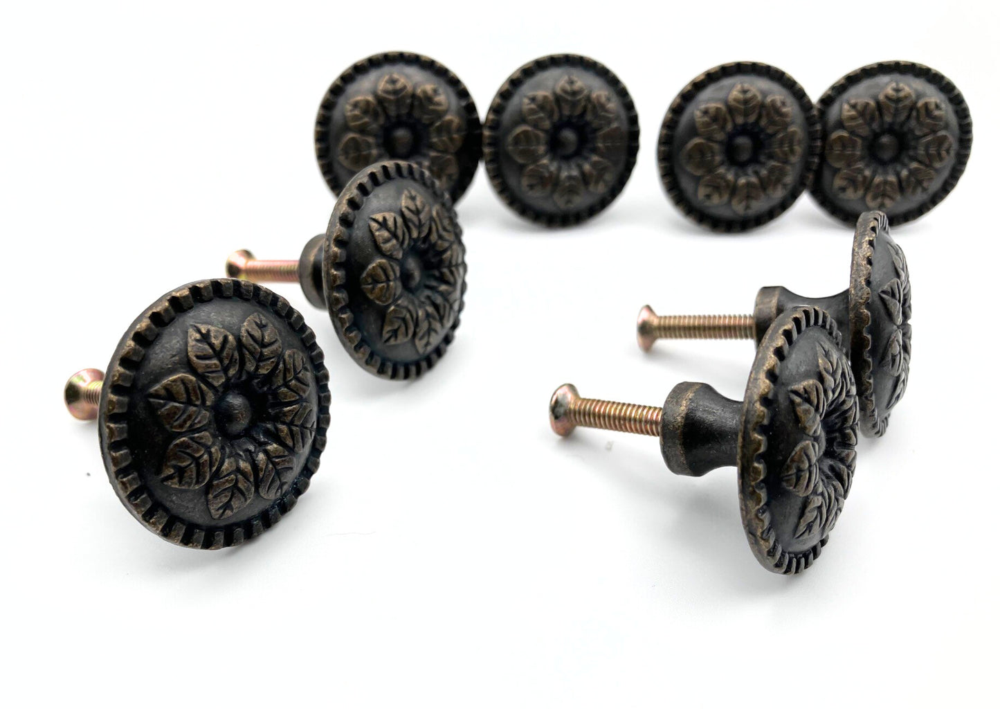 Set of ornate black cabinet knobs on a white background
