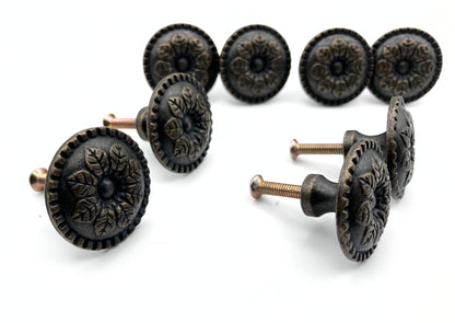 Set of ornate black cabinet knobs on a white background