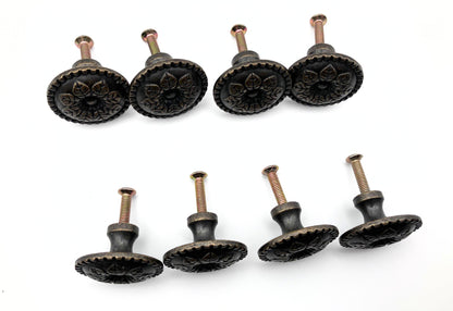 Set of eight decorative cabinet knobs on a white background