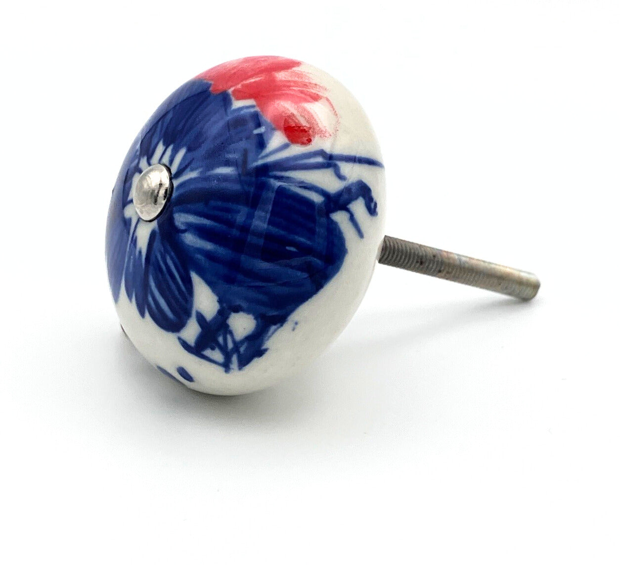 White ceramic knob with blue and red design on a white background