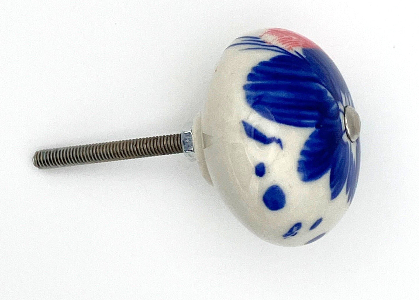 White ceramic knob with blue and red design on a white background