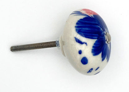White ceramic knob with blue and red design on a white background